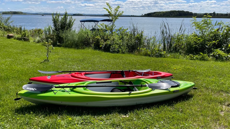 Two single kayaks ready at the shore