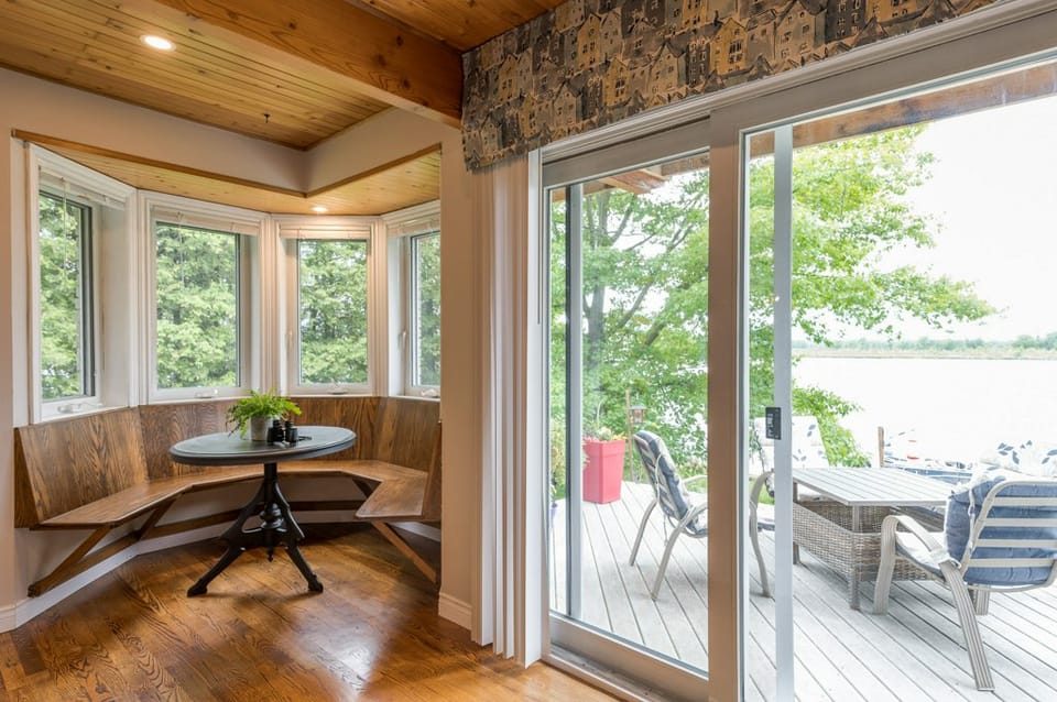Breakfast nook with bay windows and a walkout to the lakeside deck