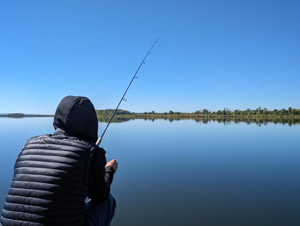 Casting a line on a calm, glassy morning